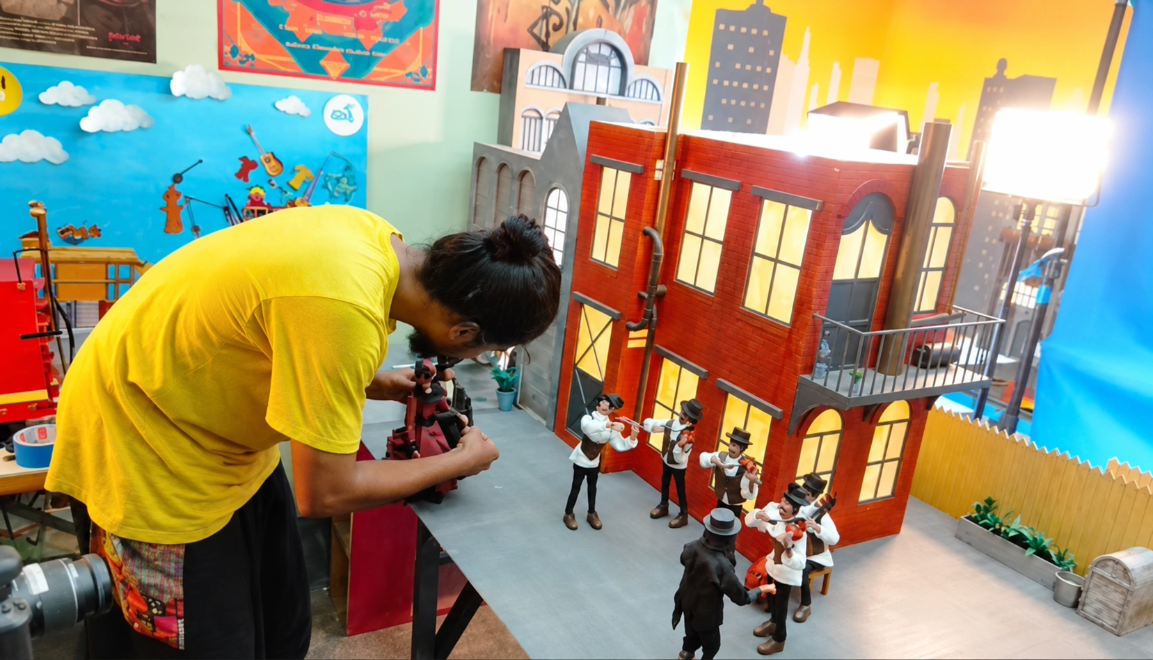 Animator working with puppets on a miniature stop-motion set